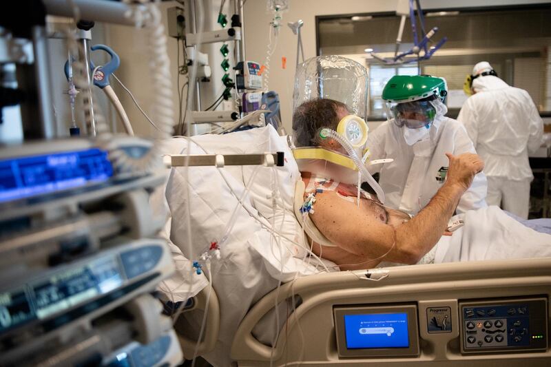 A nurse makes sure that a patient with an oxygen device is breathing properly. Getty Images