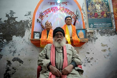 Ashok Sharma sits in front of the statues of Gandhi’s assassins, Nathuram Godse and Narayan Apte, at Godse temple, Meerut. AFP