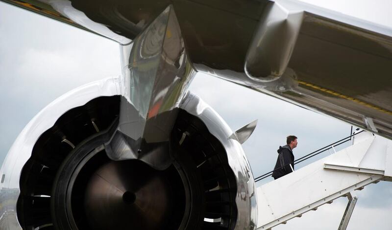 A man walks up the staircase to a Boeing 787 Dreamliner aircraft at the Farnborough International Airshow, which takes place this month.  Adrian Dennis / AFP

