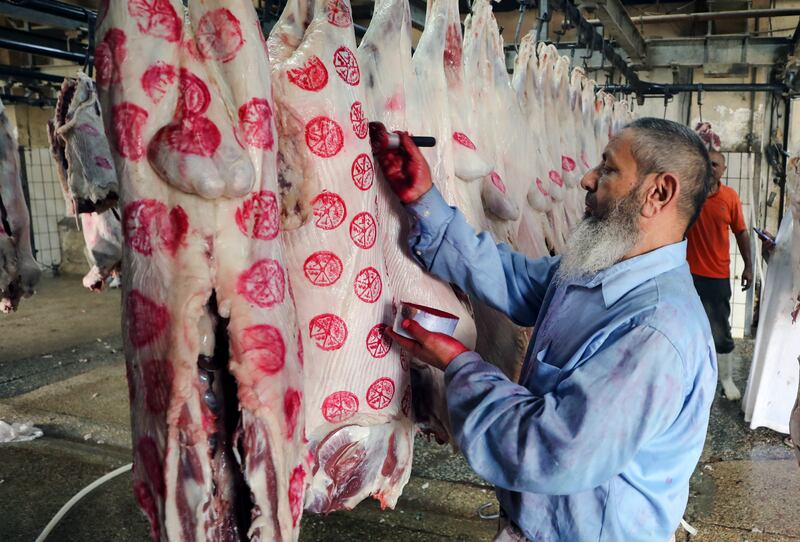 An Egyptian butcher prepares slaughtered sacrificial sheep in Cairo. EPA 