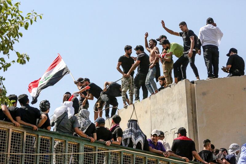 Angered by a nomination for Iraq's role of prime minister, supporters of Shiite cleric Moqtada Al Sadr haul down concrete barriers along the Al Jumhuriya Bridge that leads to Baghdad's high-security government and administration Green Zone. AFP