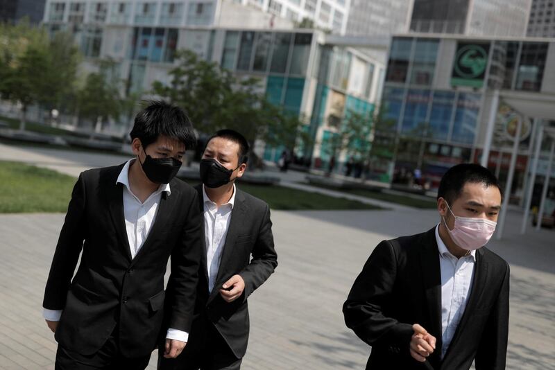 Office workers wear protective during lunch hour near Beijing’s Central Business District. Reuters