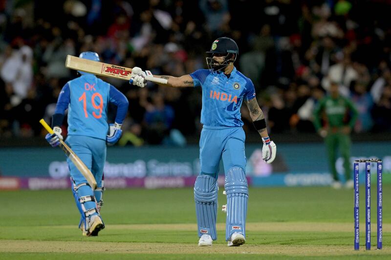 India's Virat Kohli celebrates reaching his half century. AFP