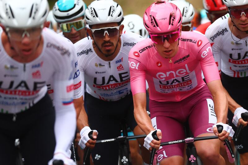 UAE Team Emirates rider Tadej Pogacar surrounded by teammates in the peloton during Stage 3 of the 107th Giro d'Italia, a 166 km race between Novara and Fossano. AFP