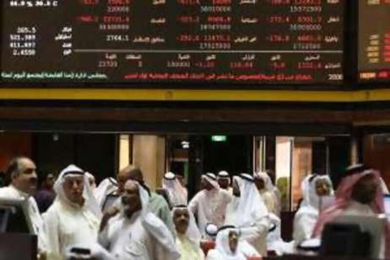 Kuwaiti traders follow the market's movement at the Stock Exchange in Kuwait City on September 15, 2008. Stock markets across the energy-rich Gulf fell sharply today, shedding up to seven percent of their value on the Lehman Brothers bankruptcy and a big drop in oil prices. Kuwait Stock Exchange, the second largest in the Arab world, closed down 3.8 percent at 12,360.20 points. It shed 488 points, the largest points loss on a single day, dropping below the 2007 close for the first time this year. AFP PHOTO/YASSER AL-ZAYYAT