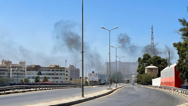 Smoke billows as gunfire rings out in the capital. AFP