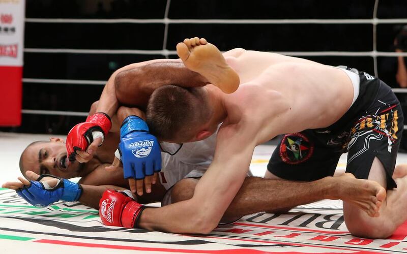 The UAE’s Ahmad Al Darmaki, in white shorts, fights with Artiyom Gorodynets from Ukraine in the Abu Dhabi Warriors 4 at IPIC Arena in Zayed Sports city in Abu Dhabi. Ravindranath K / The National