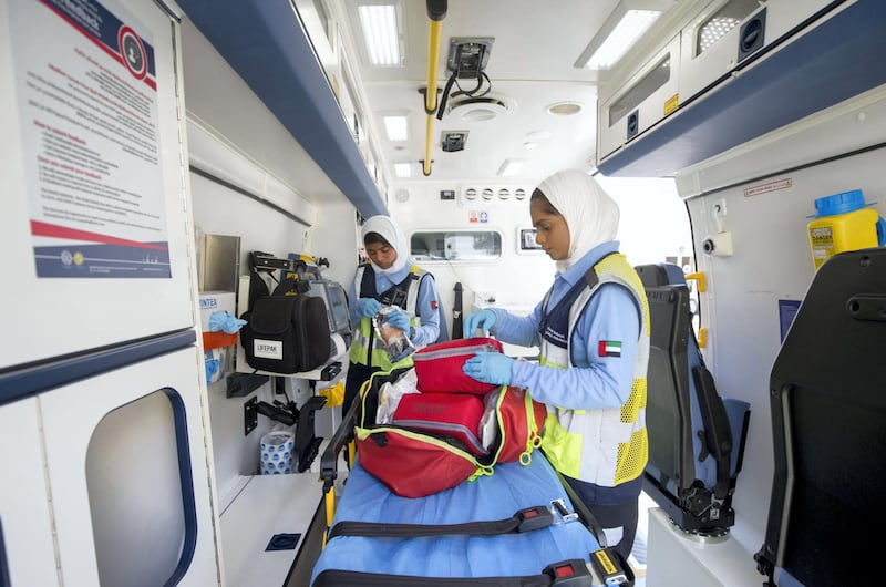 Ajman, United Arab Emirates - Emirati female EMT's Marwa Ahmad Alamoodi (L-R)and Maha Saeed Alfalasi with the national ambulance showing how they respond to a call and provide emergency treatment to residents. Ruel Pableo for The National