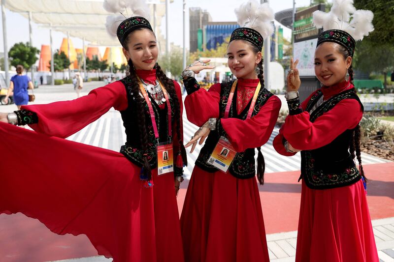 Kazakhstani women in traditional costume pose for a picture at the expo. AFP