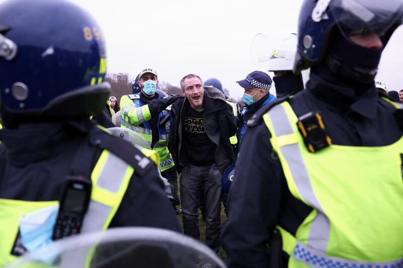 Police officers detain a person during a protest against the lockdown, amid the spread of the coronavirus disease (COVID-19), in London, Britain March 20, 2021. REUTERS/Henry Nicholls