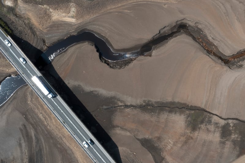 Traffic crosses a bridge at Woodhead Resevoir in West Yorkshire as water levels dip dangerously low. AP