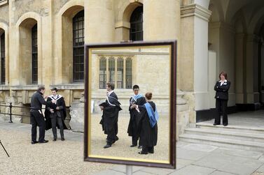 Graduates queue to have their photograph taken after a graduation ceremony at Oxford University in England. Paul Hackett/Reuters