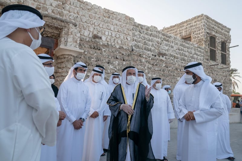 The building's eastern section includes an outer majlis overlooking the shore. Wam