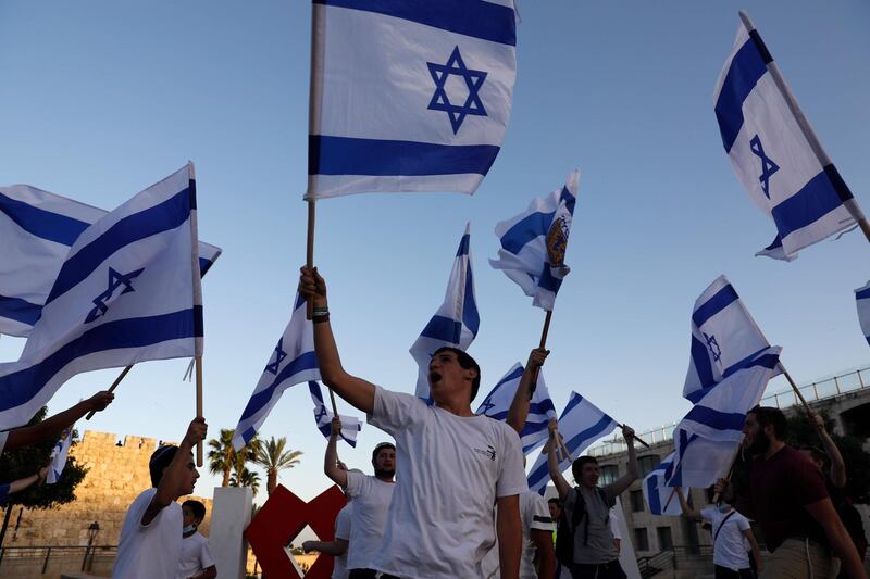 ISRAEL & PALESTINE: Right-wing Israelis wave national flags as they gather outside the Old City of Jerusalem on May 21, 2020, to mark Jerusalem Day, commemorating Israel's capture of the holy city's mainly Palestinian eastern sector in the 1967 Six-Day War. AFP