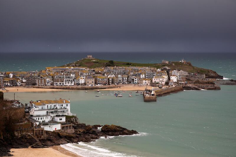 Dark clouds are seen over St Ives during New Year's Eve amid the coronavirus disease (COVID-19) outbreak, in St Ives, Cornwall, Britain December 31, 2020. REUTERS/Tom Nicholson