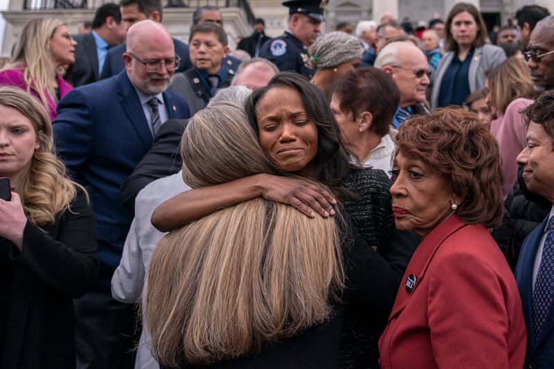 Serena Liebengood, centre, wife of late US Capitol Police Officer Howard Liebengood, is embraced by members of Congress. Getty / AFP