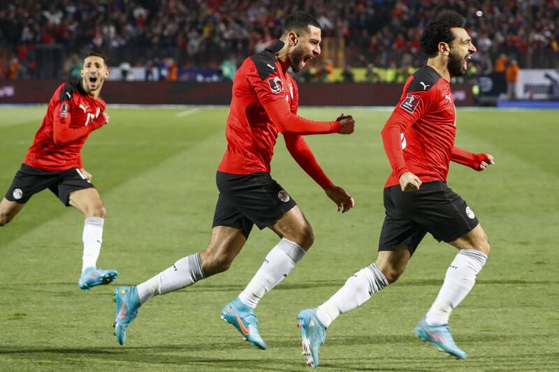 Mohamed Salah, Amr el-Solia, and Ahmed Fattoh celebrate the goal against Senegal in Cairo on Friday. AFP