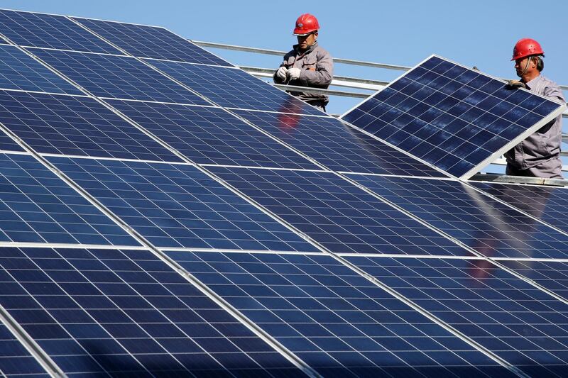 Workers install solar panels at a residential home in a village in Dongying, Shandong province, China November 22, 2017. Picture taken November 22, 2017. REUTERS/Stringer ATTENTION EDITORS - THIS IMAGE WAS PROVIDED BY A THIRD PARTY. CHINA OUT.