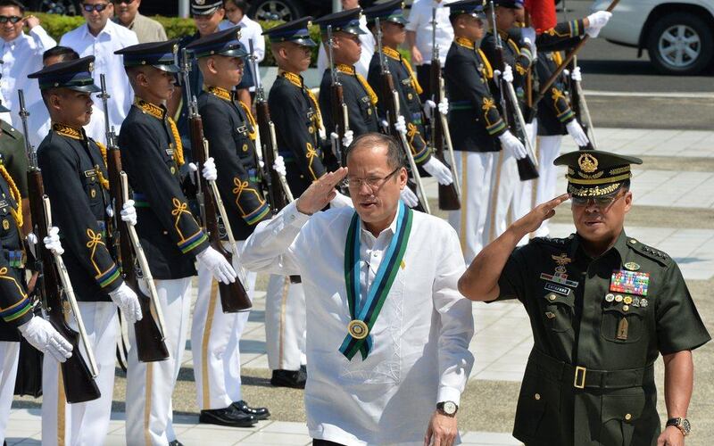 Philippine President Benigno Aquino at a distribution ceremony of M-4 assault rifles for soldiers at the Defense Department office in Manila. Aquino has said he may try to change the constitution and serve a second term in office, a stunning announcement in a nation haunted by dictatorship. TED ALJIBE / AFP