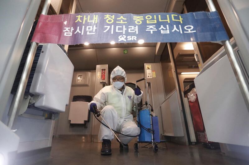 An employee sprays disinfectant on a train at Suseo Station in Seoul, South Korea. AP Photo