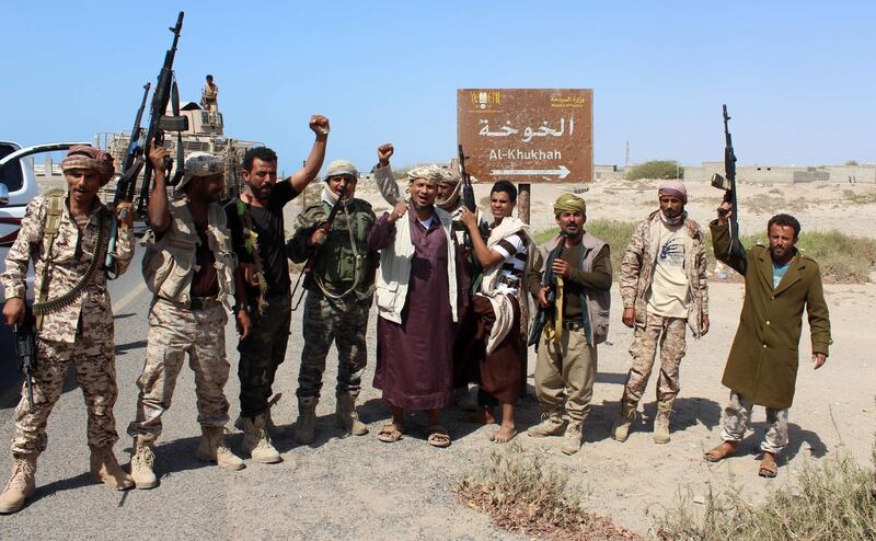 (FILES) A file photo taken on December 10, 2017 shows Yemeni fighters loyal to the Saudi-backed Yemeni president gesturing and shout slogans as they stand on a road leading to the town of Khokha which was retaken from Shiite-Huthi rebels, about 120 kilometres south of the Huthi rebel-held Red Sea port of Hodeida.  / AFP / SALEH AL-OBEIDI

