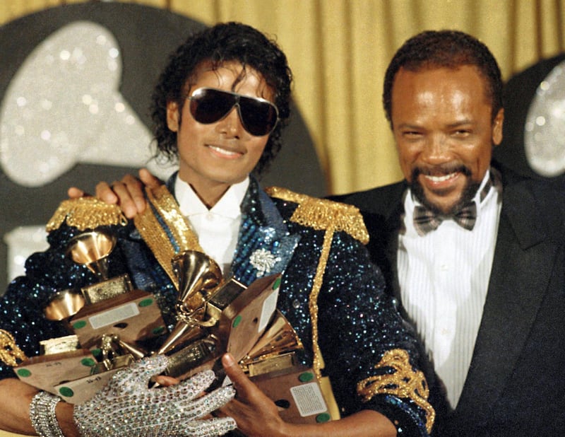 FILE - In this Feb. 28, 1984 file photo, Michael Jackson, left, holds eight awards as he poses with Quincy Jones at the Grammy Awards in Los Angeles. On Wednesday, July 26, 2017, a jury found that Jackson‚Äôs estate owes Jones $9.4 million in royalties and production fees from ‚ÄúBillie Jean,‚Äù ‚ÄúThriller‚Äù and more of the superstar‚Äôs  biggest hits. (AP Photo/Doug Pizac, File)