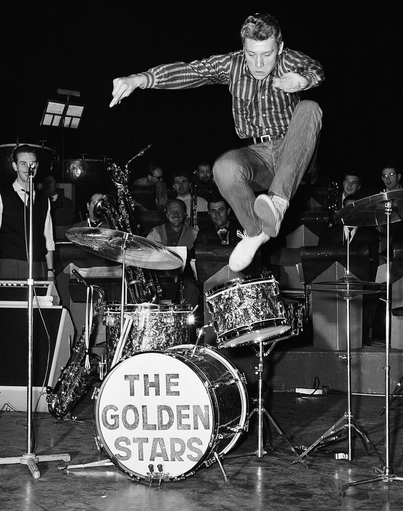 FILE - This Oct. 22 1962 shows French pop singer, Johnny Hallyday, leaps into the air whilst rehearsing at the Olympia Theater in Paris. The French president's office says Hallyday, who packed sports stadiums for decades, has died at age 74. (AP Photo/Jean Jacques Levy, File)