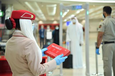 Emirates is giving all travellers hygiene kits containing gloves and face masks. Travellers from several destinations must also take a Covid-19 test before boarding Emirates flights. 