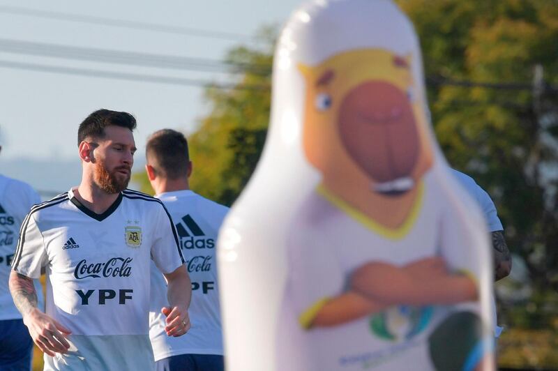 Argentina's Lionel Messi trains next to a plastic toy. AFP