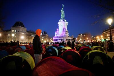 Migrants set up tents on the Place de la Republique square for the start of a "Night of Solidarity" organised by the Collectif Requisitions to draw attention to their living conditions and to demand accommodation in Paris, France, March 25, 2021. REUTERS/Benoit Tessier