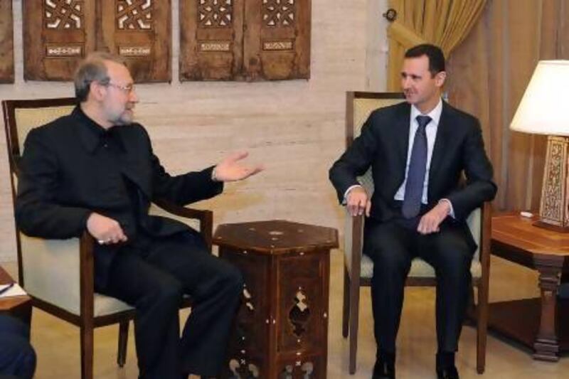 Syria's president, Bashar Al Assad, right, meets with the speaker of the Iranian parliament, Ali Larijani, in Damascus on Friday.