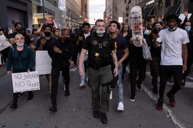 Violent protests erupted across the US over the death of George Floyd, a black man in police custody. AFP