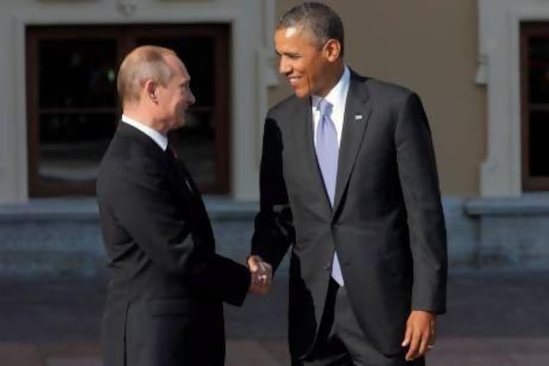 Russia's president Vladimir Putin, left, shakes hands with his US counterpart Barack Obama during arrivals for the G-20 summit in St. Petersburg.