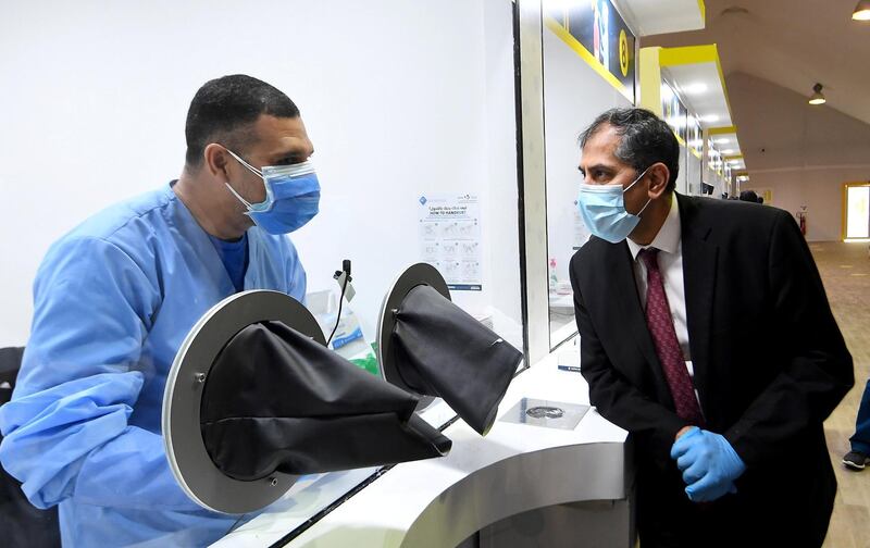 Abu Dhabi, United Arab Emirates, May 6, 2020. the new Ambulatory Healthcare Services, a SEHA Health System Facility, National Screening Project in Mussafah Industrial Area in Abu Dhabi. ‚ÄîIndia‚Äôs new Ambassador to the UAE Pavan Kapoor with one of the medical staff of the center.
Victor Besa / The National
Section:  NA
Reporter:  Nick Webster