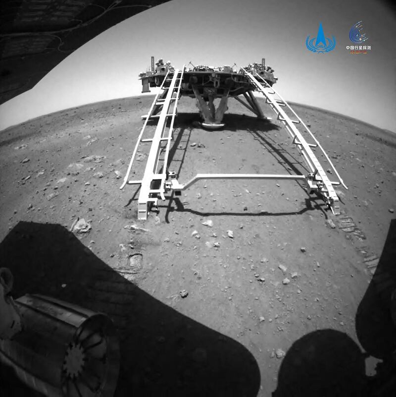 An image taken by the rear obstacle avoidance camera of China's Zhurong Mars rover showing the landing platform of the Tianwen-1 Mars probe, after the rover drove down the ramp onto the surface of Mars. AFP
