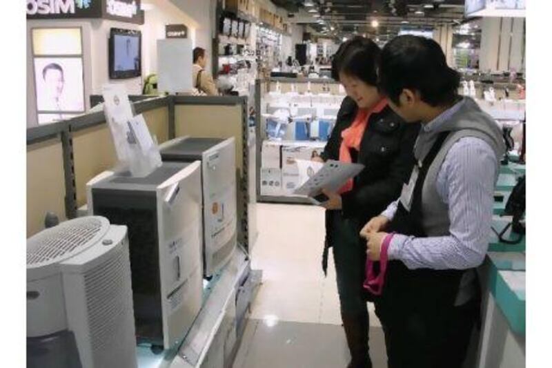 People shop for air purifiers in Beijing, where air quality has become a hot topic.