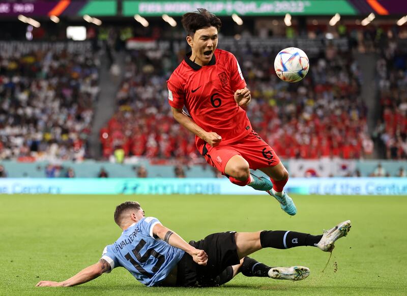 Hwang In-beom battles for possession with Federico Valverde of Uruguay. Getty