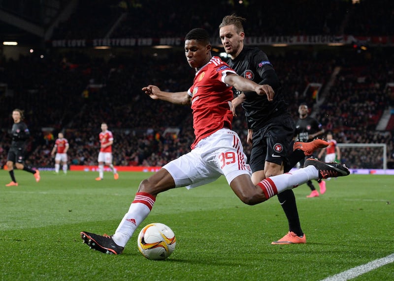 Manchester United's English striker Marcus Rashford (L) vies with FC Midtjylland's Danish defender Kian Hansen during the UEFA Europa League round of 32, second leg football match between Manchester United and and FC Midtjylland at Old Trafford in Manchester, north west England, on February 25, 2016. - Manchester United won the match 5-1. (Photo by OLI SCARFF / AFP)