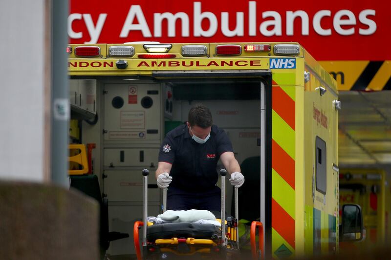 A paramedic moves a stretcher inside an ambulance at St Thomas' Hospital. Getty Images