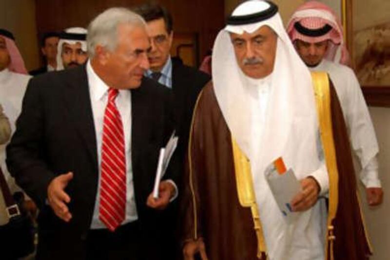 The director of the International Monetary Fund (IMF) Dominique Strauss-Kahn (L) walks with Saudi Finance Minister Ibrahim al-Assaf following a meeting of the Gulf Cooperation Council (GCC) finance ministers in the Saudi Red Sea city of Jeddah on September 17, 2008. Finance ministers of oil-rich Gulf states are expected to approve a proposal to set up a monetary council but the launch date for a single currency remains unclear. The monetary council, agreed in principle by central bank governors of the GCC states in 2006, would be the forerunner for the GCC central bank, which will issue the single currency. AFP PHOTO/OMAR SALEM *** Local Caption ***  291172-01-08.jpg