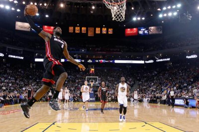 LeBron James dunks for Miami Heat against Golden State Warriors on his way to breaking the 20,000 points barrier.