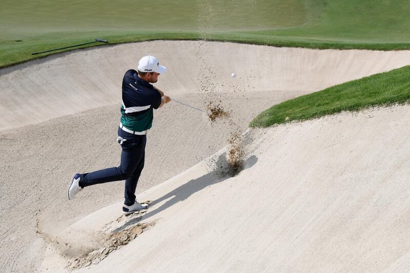 Tyrrell Hatton hits his third shot on the 18th hole during the second round of the DP World Tour Championship. Ross Kinnaird / Getty Images