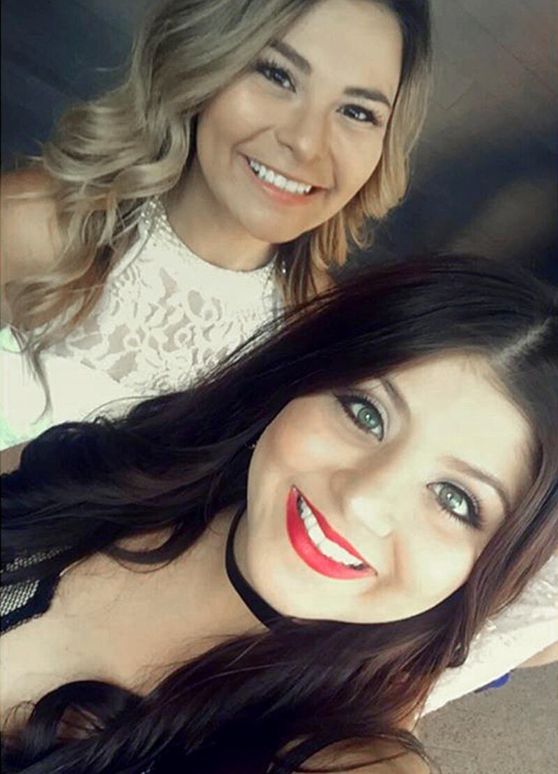 This photo provided by Marissa Nino shows a spring, 2017 self-portrait by her cousin Karessa Royce, 22, lower right, and her friend Pam Rios in Las Vegas. When Royce was wounded in the mass shooting in Las Vegas Sunday, Oct. 1, 2017, Rios rushed her to an ambulance which took her to a hospital. She was shot in the shoulder and is in intensive care following surgery for a collapsed lung, but is expected to survive. (Marissa Nino/Karessa Royce via AP)