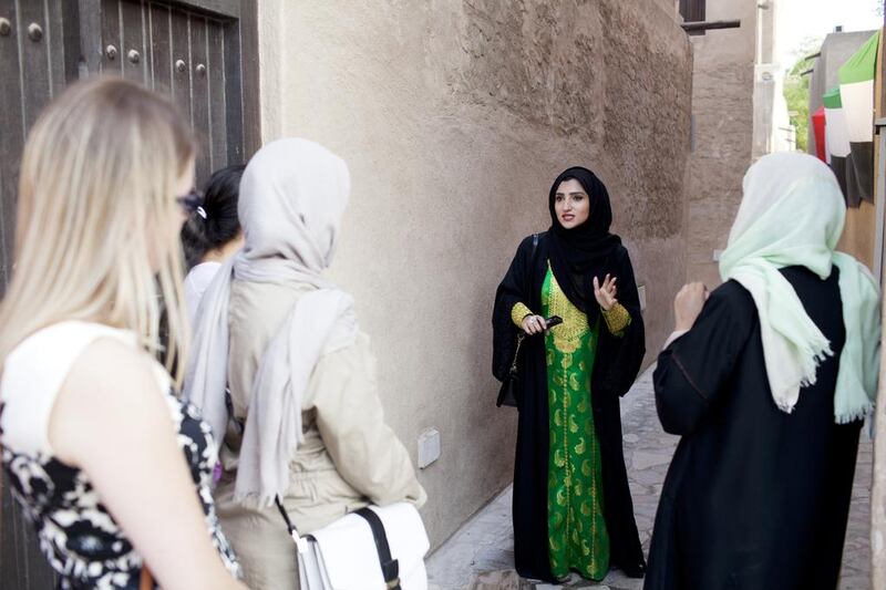 Heba bin Redha, founder of tour company Kashta With Heba, takes a group on a walk around Old Dubai. Anna Nielsen for The National 