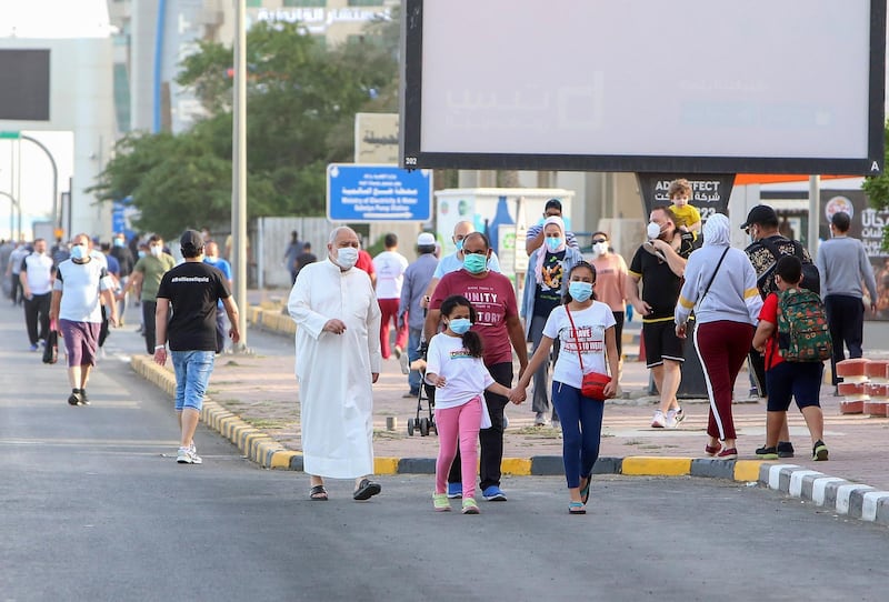 Residents walk in a neighbourhood of Kuwait City as authorities allowed people to exercise for two hours under nationwide lockdown rules.  AFP