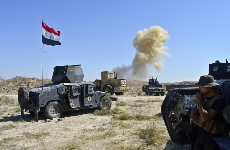 Smoke rises as Iraqi counterterrorism forces face off with ISIL fighters on the southern edge of Fallujah on Tuesday. Osama Sami/AP Photo