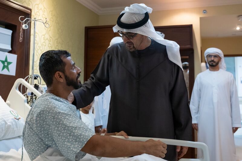 Sheikh Mohamed speaks with Capt Al Nuaimi at the military hospital
