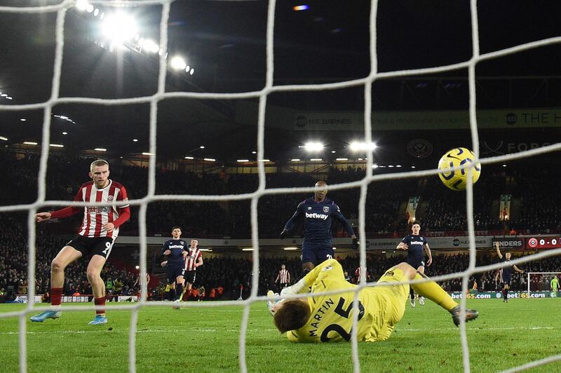 Sheffield United's Oliver McBurnie beats West Ham United goalkeeper David Martin to score. AFP