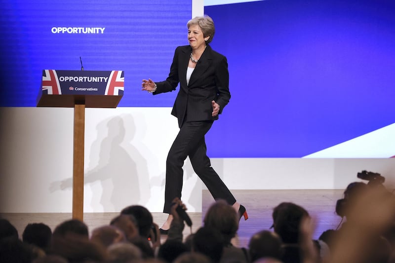 Britain's Prime Minister Theresa May dances a few steps as she takes the stage to give her keynote address on the fourth and final day of the Conservative Party Conference 2018 at the International Convention Centre in Birmingham, central England, on October 3, 2018. (Photo by Paul ELLIS / AFP)