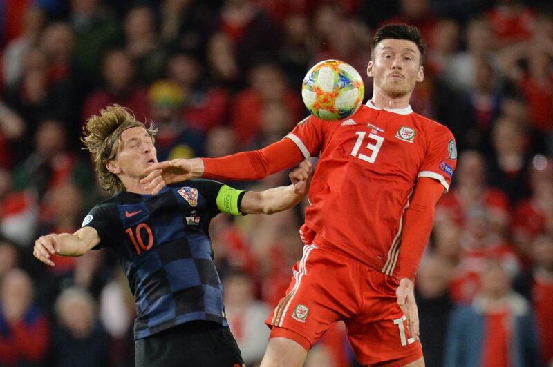 epa07918975 Wales Kieffer Moore (R) in action against Croatia's Luka Modric (L) during the UEFA EURO 2020 group E qualifier soccer match between Wales and Croatia held at Cardiff City Stadium in Wales, Britain, 13 October 2019.  EPA/PETER POWELL